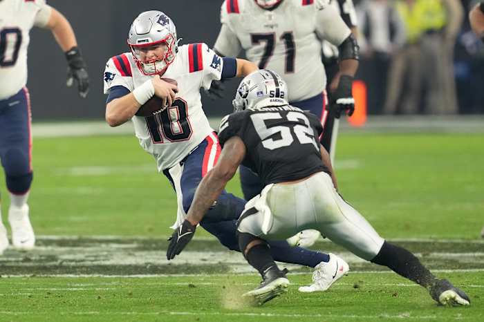 Dec 18, 2022; Paradise, Nevada, USA; New England Patriots quarterback Mac Jones (10) is flushed from the pocket by the Las Vegas Raiders during the second half at Allegiant Stadium.